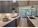Modern kitchen boasts gray cabinets, subway tile backsplash, stainless steel appliances, and dining area access at 2108 New Hope Church Rd, Chapel Hill, NC 27514