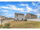 Spacious backyard showcasing a well-maintained lawn, patio set, and neighborhood view at 211 Azalea Gaze Dr, Youngsville, NC 27596