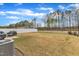 Large backyard featuring a well-kept lawn, fence, and scenic view of distant trees at 211 Azalea Gaze Dr, Youngsville, NC 27596
