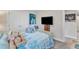 Comfortable bedroom with a soft bed, colorful art, and a flat screen television at 211 Azalea Gaze Dr, Youngsville, NC 27596