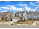 Charming two-story home with gray siding, stone accents, and a two-car garage at 211 Azalea Gaze Dr, Youngsville, NC 27596