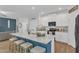 Open concept kitchen with an island, stainless appliances, granite countertops, and stool seating at 211 Azalea Gaze Dr, Youngsville, NC 27596