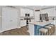 Kitchen features an island with bar stool seating, stainless appliances, and granite countertops at 211 Azalea Gaze Dr, Youngsville, NC 27596