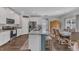 Bright open kitchen boasts granite countertops, stainless appliances, and a dining space at 211 Azalea Gaze Dr, Youngsville, NC 27596