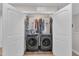 Convenient laundry closet featuring a washer, dryer, and ample storage space at 211 Azalea Gaze Dr, Youngsville, NC 27596