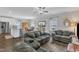 Cozy living room featuring hardwood floors, neutral walls, and comfortable leather sofas at 211 Azalea Gaze Dr, Youngsville, NC 27596