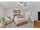 Cozy main bedroom with accent chair, soft carpet, and natural light at 211 Azalea Gaze Dr, Youngsville, NC 27596