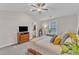 Bright main bedroom boasts a ceiling fan, neutral walls, and ensuite bathroom access at 211 Azalea Gaze Dr, Youngsville, NC 27596