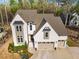 Aerial view of a two-story home with a neutral color scheme and a well-manicured front yard at 215 Bonterra Way, Chapel Hill, NC 27516