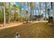 Shot of wooded backyard with house and trampoline at 215 Bonterra Way, Chapel Hill, NC 27516