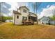 Backyard view with spacious lawn, deck, and manicured landscaping at 215 Bonterra Way, Chapel Hill, NC 27516
