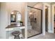 This modern bathroom features a glass shower and vanity area with a black framed mirror at 215 Bonterra Way, Chapel Hill, NC 27516