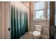 Full bathroom with shower featuring modern fixtures, a tiled shower, and large window at 215 Bonterra Way, Chapel Hill, NC 27516