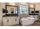 This bathroom features a soaking tub, windows for natural light, and and sinks at 215 Bonterra Way, Chapel Hill, NC 27516