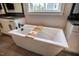 This bathroom features a soaking tub with white cabinets and dark countertops around the perimeter at 215 Bonterra Way, Chapel Hill, NC 27516