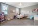 Cozy bedroom features two windows, carpet, and light-colored walls with white trim at 215 Bonterra Way, Chapel Hill, NC 27516