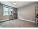 Spacious room with large windows and recessed lighting; neutral gray walls and trim at 215 Bonterra Way, Chapel Hill, NC 27516