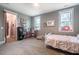 Sunlit bedroom with carpet, two windows, and doorway; light-colored walls and trim at 215 Bonterra Way, Chapel Hill, NC 27516