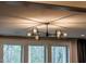 Stylish chandelier with exposed bulbs and expansive window at 215 Bonterra Way, Chapel Hill, NC 27516