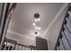 Elegant chandelier with frosted geometric lights and oak trim at 215 Bonterra Way, Chapel Hill, NC 27516