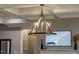 Modern chandelier with a coffered ceiling and a smart TV at 215 Bonterra Way, Chapel Hill, NC 27516