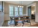 Bright dining room with a modern farmhouse table, bench seating, and large windows at 215 Bonterra Way, Chapel Hill, NC 27516