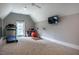 Bright exercise room with a vaulted ceiling, large window and TV creating an inspiring workout space at 215 Bonterra Way, Chapel Hill, NC 27516