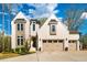 Charming two-story home featuring a light brick facade and attached two-car garage at 215 Bonterra Way, Chapel Hill, NC 27516
