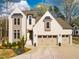 Stunning home featuring a brick facade, two-car garage, and professionally landscaped front yard at 215 Bonterra Way, Chapel Hill, NC 27516