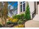 Front yard featuring a brick facade, trimmed bushes, and a well-manicured landscape at 215 Bonterra Way, Chapel Hill, NC 27516