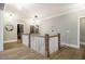 Upstairs hallway with hardwood floors, decorative lighting, and neutral wall color at 215 Bonterra Way, Chapel Hill, NC 27516