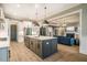 Open concept kitchen and living room featuring an island with seating and modern decor at 215 Bonterra Way, Chapel Hill, NC 27516