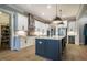 Modern kitchen features an island with seating, stainless steel appliances, and white cabinets at 215 Bonterra Way, Chapel Hill, NC 27516
