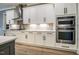 This kitchen features white cabinets, stainless steel appliances and a decorative backsplash at 215 Bonterra Way, Chapel Hill, NC 27516