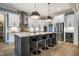 Modern kitchen features an island with seating, stainless steel appliances, and white cabinets at 215 Bonterra Way, Chapel Hill, NC 27516