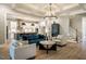 Open concept kitchen and living room featuring an island with seating and modern decor at 215 Bonterra Way, Chapel Hill, NC 27516