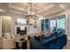Bright living room featuring a fireplace, built-in shelving, coffered ceilings and access to an outdoor porch at 215 Bonterra Way, Chapel Hill, NC 27516