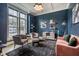 Stylish living room with dark blue walls, modern furniture, and large windows at 215 Bonterra Way, Chapel Hill, NC 27516