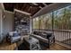 Enjoy this relaxing covered patio featuring stone fireplace and wood ceiling overlooking a serene view of nature at 215 Bonterra Way, Chapel Hill, NC 27516