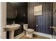 Chic powder room featuring modern fixtures, stylish wallpaper, and a round mirror at 215 Bonterra Way, Chapel Hill, NC 27516