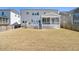 Backyard view featuring a screened porch, deck, and well-maintained lawn at 216 Ocean Jasper Dr, Holly Springs, NC 27540