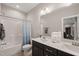 Bright bathroom featuring a double sink vanity, framed mirror, and a shower/tub combo with curtain at 216 Ocean Jasper Dr, Holly Springs, NC 27540