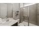 Modern bathroom featuring a glass door shower, single sink vanity, and neutral color palette at 216 Ocean Jasper Dr, Holly Springs, NC 27540