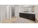 Bright bathroom with wood-look tile, a dark vanity with white top, and access to a bedroom at 216 Ocean Jasper Dr, Holly Springs, NC 27540