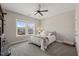Neutral bedroom with a ceiling fan, and large windows overlooking neighborhood at 216 Ocean Jasper Dr, Holly Springs, NC 27540