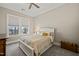 Comfortable bedroom with a ceiling fan, carpeted floor, and a large window for natural light at 216 Ocean Jasper Dr, Holly Springs, NC 27540