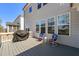 Back deck with seating, grill, and a view of the surrounding neighborhood and backyard at 216 Ocean Jasper Dr, Holly Springs, NC 27540