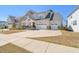 Two-story home featuring a three-car garage and well-manicured front yard at 216 Ocean Jasper Dr, Holly Springs, NC 27540
