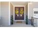 Welcoming front entrance with double doors decorated with wreaths and a 'Welcome' mat at 216 Ocean Jasper Dr, Holly Springs, NC 27540