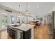 Open-concept kitchen and living area with hardwood floors, natural light, and modern finishes at 216 Ocean Jasper Dr, Holly Springs, NC 27540